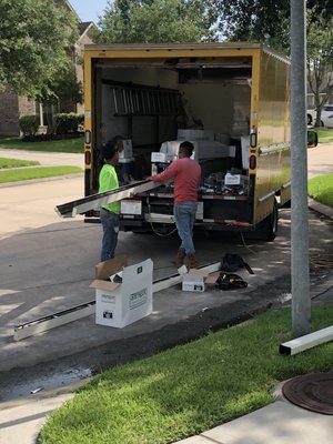 Crew working with gutter equipment from a service vehicle